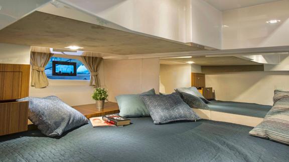 The cozy double cabin of motor yacht 7 Happy days features a comfortable bed and modern amenities.