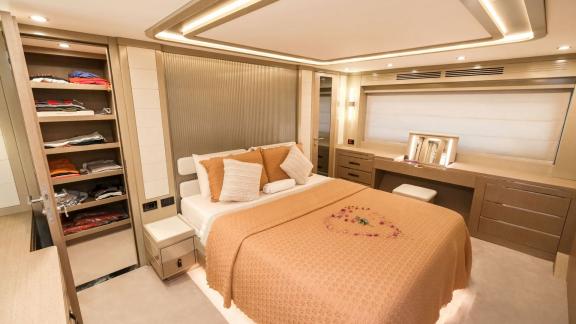 The master cabin on yacht La Luna offers comfort with ample storage space and a cozy bed.