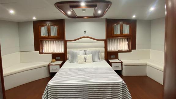 The master cabin of gulet Rose Sah offers a large bed and a comfortable seating area.