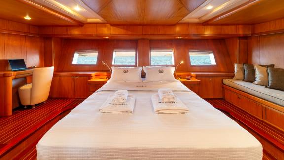 The master cabin of Mein Schatz offers a comfortable living space with a sea view, perfect for a weekly gulet charter in