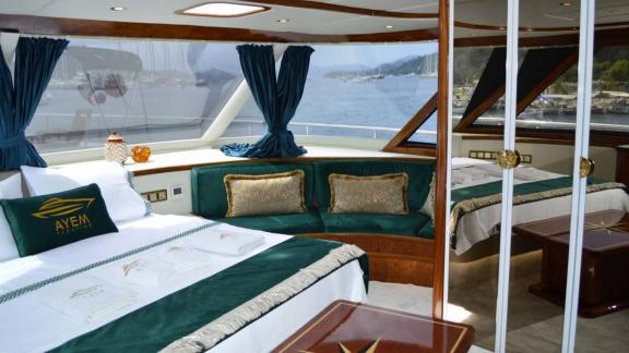 Ayem yacht in Göcek features a master cabin with wide bay windows and sea views.