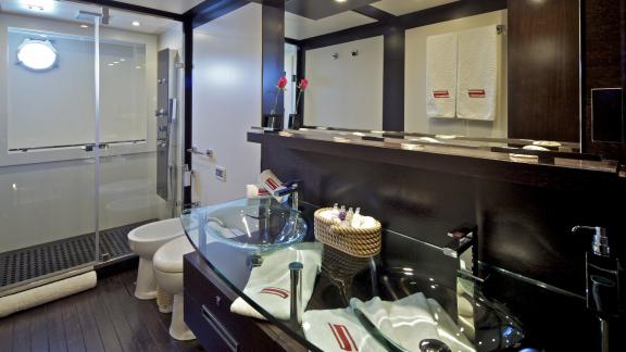 Elegant bathroom with double sinks and a spacious shower on the motor yacht Thea Malta.