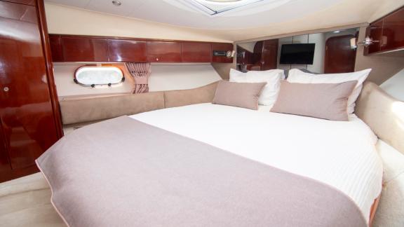 The master cabin of motor yacht NateWhite offers a large bed and comfortable space.