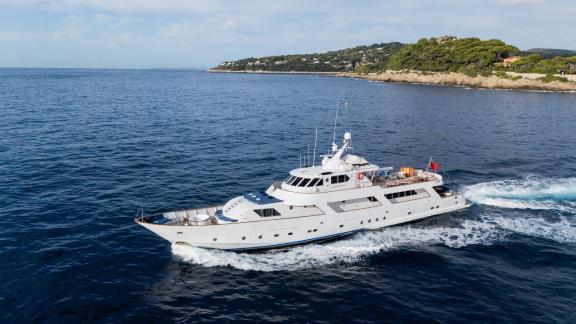Among Cannes daily yacht rental options Ava motor yacht is seen cruising at sea from side view.