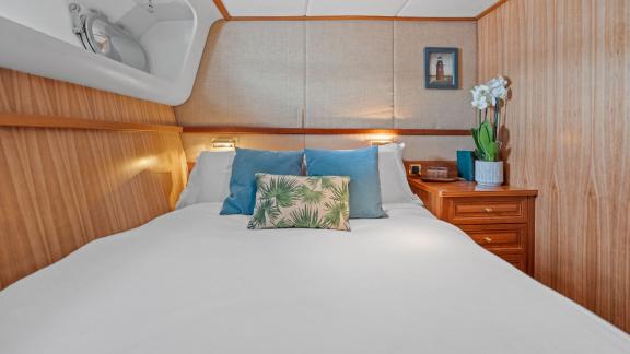 Among Cannes daily yacht rental options Ava motor yacht cabin shows large bed with stylish interior design.