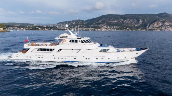 Among Cannes daily yacht rental options Ava motor yacht is seen cruising calmly at sea from side view.