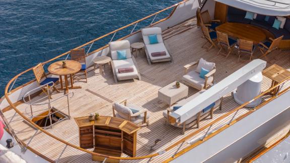 Among Cannes daily yacht rental options Ava motor yacht upper deck shows loungers and seating area for relaxation.