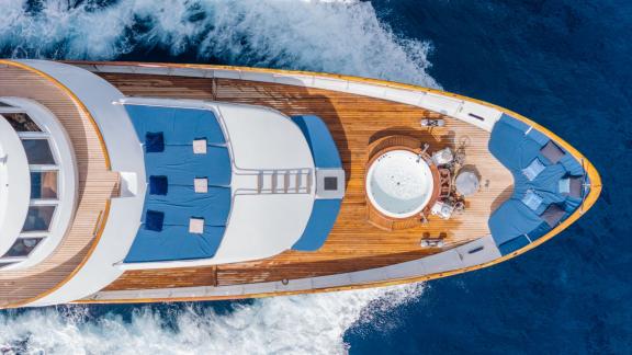 Among Cannes daily yacht rental options Ava motor yacht top view shows jacuzzi and seating on front deck.