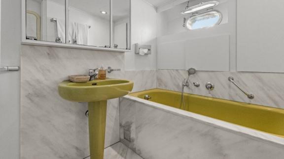 Among Cannes daily yacht rental options Ava motor yacht bathroom shows bathtub and sink with spacious design.