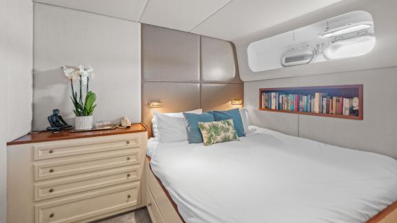 Among Cannes daily yacht rental options Ava motor yacht cabin shows bed with elegant interior design.