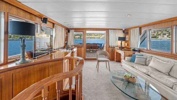 Among Cannes daily yacht rental options Ava motor yacht interior shows lounge with bar and seating area.