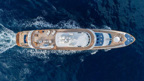 Among Cannes daily yacht rental options Ava motor yacht is seen from above cruising in open sea.