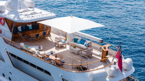 Among Cannes daily yacht rental options Ava motor yacht upper deck shows shaded seating area for relaxation.