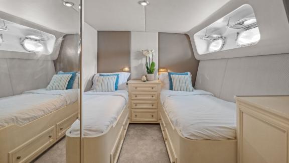 Among Cannes daily yacht rental options Ava motor yacht cabin shows two separate beds for comfort.