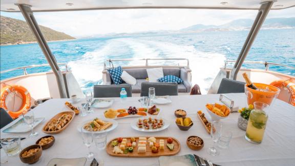 Bona Dea motor yacht in Gocek offers an aft deck dining space with sea views during private yacht holidays.