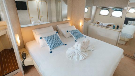 The Bona Dea motor yacht features a bright cabin with a double bed, mirrors and windows bringing in natural light.