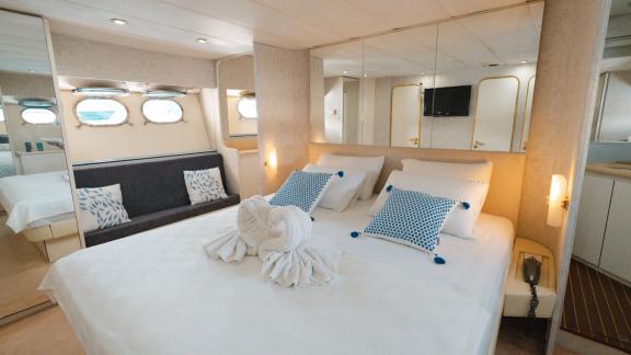 The Bona Dea motor yacht features a spacious master cabin with a double bed, mirrored cabinets and seating area.