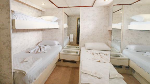 The Bona Dea motor yacht features a guest cabin with bunk beds, mirrored wardrobes and a compact layout.