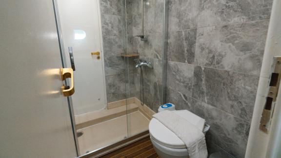 The Bona Dea motor yacht features a guest bathroom with a glass shower cabin and a practical interior layout.
