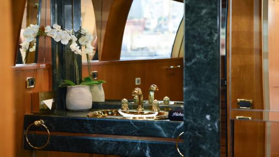 Elegant bathroom with marble countertop and gold-tone fixtures.