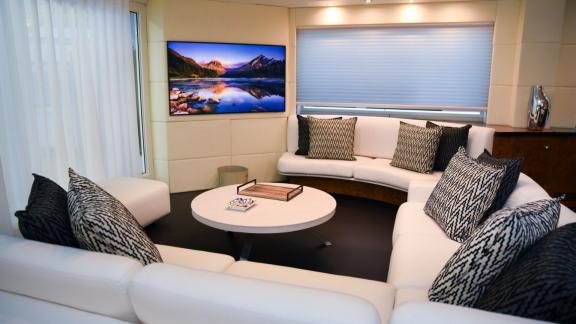 A spacious and modern seating arrangement paired with a wall-mounted TV.