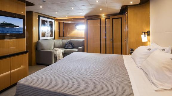 Luxurious master cabin with sofa on the 35m motor yacht in Mykonos.