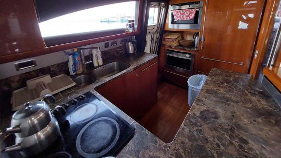 The kitchen of the yacht Cielo is equipped with modern appliances, a spacious countertop, and a stove.