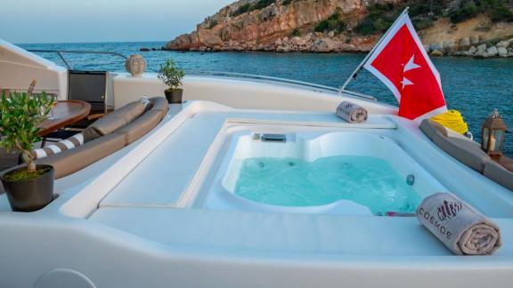 Enjoy peaceful sea views while unwinding in Cosmos yacht's jacuzzi on the upper sun deck.