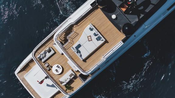 Spacious sun deck of Dawo with lounge areas and elegant design cruising on the sea.