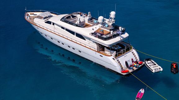 Dream motor yacht anchored in Athens, with tender and water toys visible on the swim platform.
