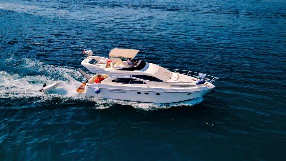 Motor yacht Ela cruising on the blue sea, enjoying the open ocean.