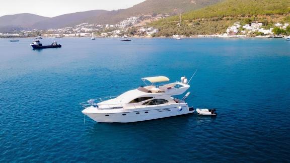 Motor yacht Ela peacefully anchored in the blue waters of Bodrum.