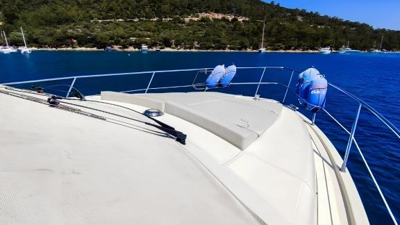 The front deck of motor yacht Ela offers a comfortable sunbathing area and sea view.