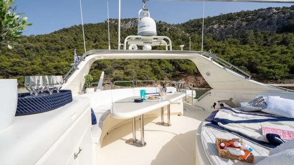 Anchored in an Athens bay the 4 cabin 10 guest Estia Poseidon motor yacht features a flybridge lounge with seating and t