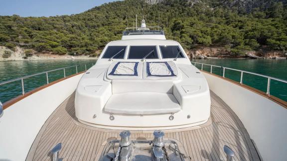 Anchored in an Athens bay the 4 cabin 10 guest Estia Poseidon motor yacht features a spacious foredeck sun lounge area.