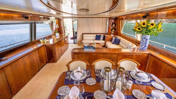 Off Athens the 4 cabin 10 guest Falcon 86 Estia Poseidon motor yacht features a stylish saloon with lounge seating and d