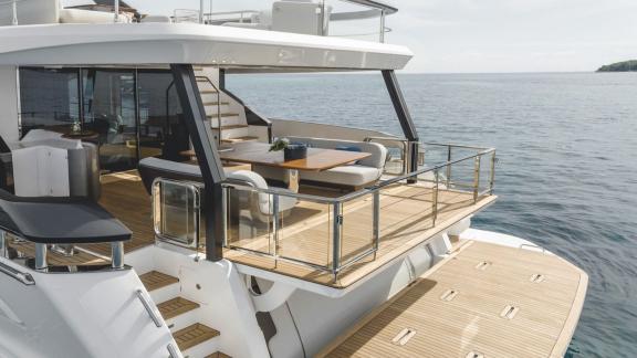 In Sibenik motor yacht charter option First Horizon aft deck with balcony seating and swim platform visible.