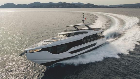 In Sibenik motor yacht charter option First Horizon cruising with visible wake trail behind at sea.