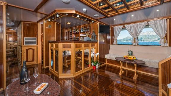 Korab’s saloon features a cozy bar corner and polished wooden interior accents.