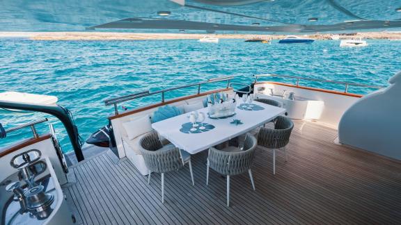 Among Ibiza luxury yacht charter options, Lady KC is seen with a sea view dining area on the aft deck.