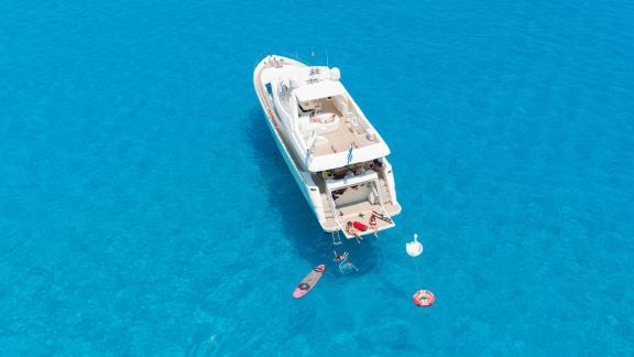 Among motor yacht rental options in Rhodes Lady Natassa aft deck shows swimming and water toys while anchored.