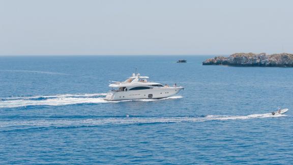 Among motor yacht rental options in Rhodes Lady Natassa is seen cruising with side view in open sea.
