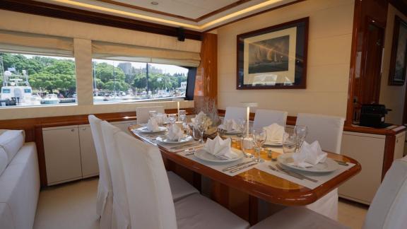 Among motor yacht rental options in Rhodes Lady Natassa dining area with table setting is seen onboard.