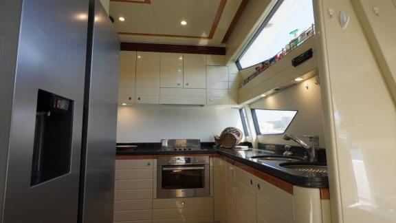 Among motor yacht rental options in Rhodes Lady Natassa kitchen shows oven sink and storage for onboard use.