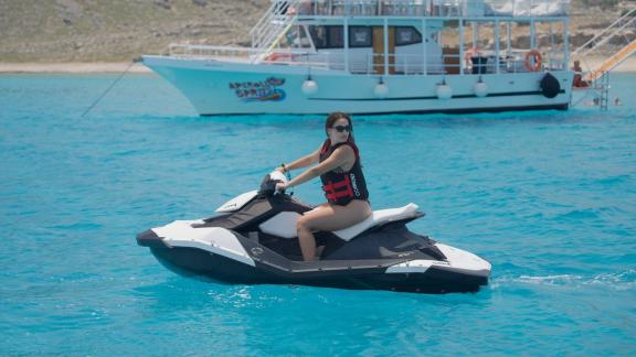 Among motor yacht rental options in Rhodes Lady Natassa is seen with jetski and water activity in the sea.