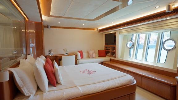 Among motor yacht rental options in Rhodes Lady Natassa cabin with bed window and seating area is seen.
