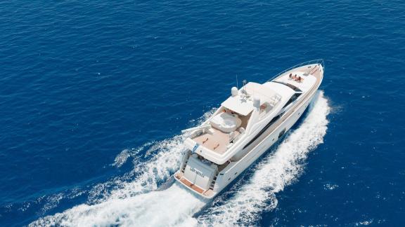 Among motor yacht rental options in Rhodes Lady Natassa is seen cruising with upper deck and wide hull in open sea.