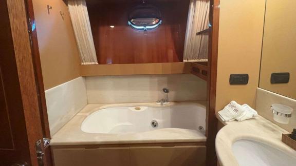 Among Athens yacht options bathroom of Mammas motor yacht with bathtub and sink.