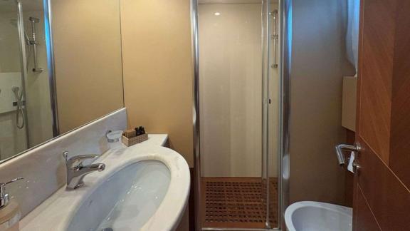 Among Athens yacht options bathroom of Mammas motor yacht with shower cabin and sink.