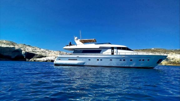 Mammas motor yacht anchored near Athens offering luxury yacht charter at sea. Four cabins provide comfortable stay for 8